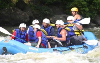 Groupraftingshotgoingleft - FAMILIES LOVE RIVER TIME AT WILDWATER RAFTING AND CANOPY TOURS!